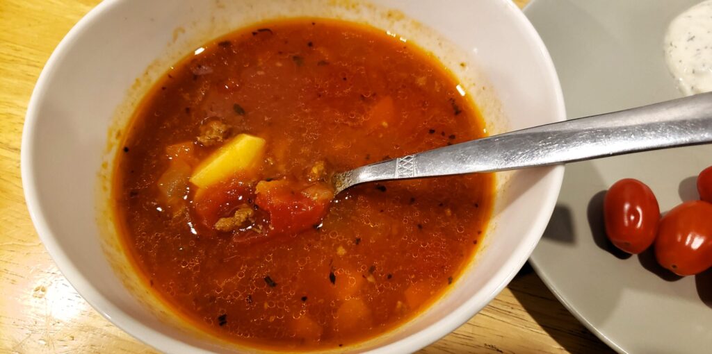Bowl of hearty hamburger soup with ground beef, potatoes, and rich tomato broth