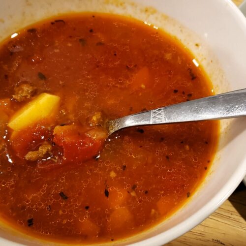 Bowl of hearty hamburger soup with ground beef, potatoes, and rich tomato broth